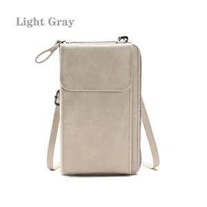 Detailed view of light gray textured crossbody phone bag with zipper and front flap pocket