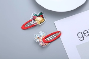 Detail of red Christmas hair clips with golden bell and glittery elk horn for girls