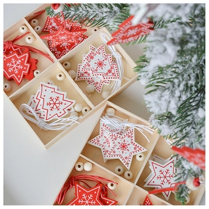 Detail of red and white wooden Nordic Christmas ornaments in a sorted storage box