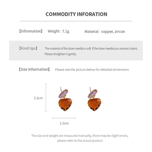 Detail view of heart-cut amber zircon earrings with copper base and silver needle