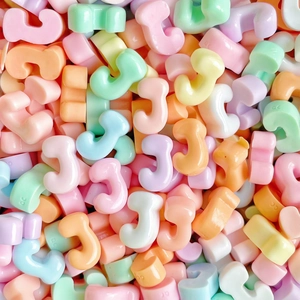 Close-up of colorful resin number 3 charms for DIY craft making and phone case decor
