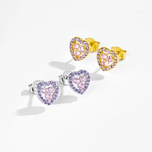 Detail of silver and gold heart earrings with pink gems and purple micro-pave crystals
