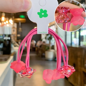Close-up of pink gummy bear hair ties set with matte and transparent resin teddy charms