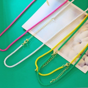 Detail of colorful enamel box chains with adjustable gold-plated lobster clasps