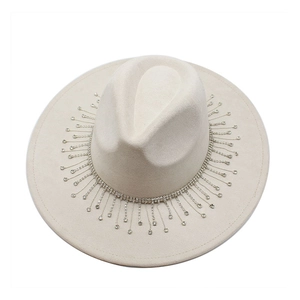 Close-up of beige fedora hat featuring sparkling rhinestone fringe and wool texture