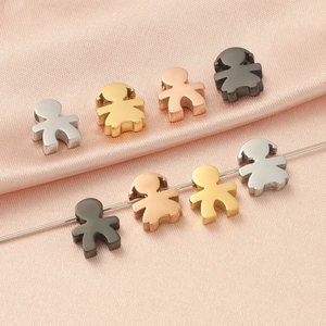 Mirror polished boy and girl titanium steel pendants in four colors on pink silk fabric