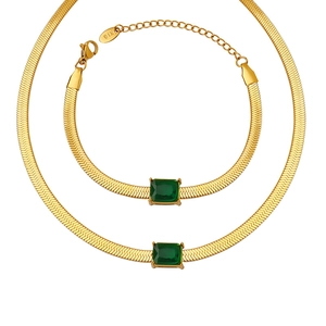 Golden flat snake chain jewelry set featuring a necklace and bracelet with green zircon