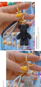 Detailed view of rhinestone teddy bear keychain with silver and black crystal finish