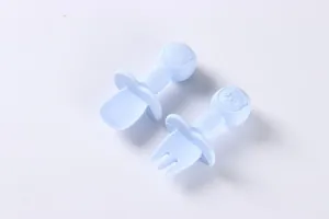 Detail of blue silicone baby spoon and fork set with cute panda design on wooden handles