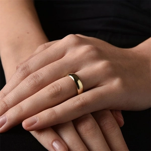 Elegant 18k gold plated stainless steel plain ring worn by model in cinematic low light