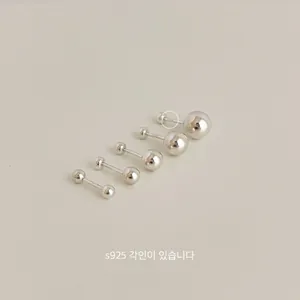 Macro detail of five S925 sterling silver ball stud earrings in various sizes