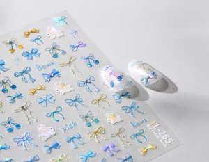 Detailed macro view of TL-265 holographic bow and rabbit nail art stickers with laser finish