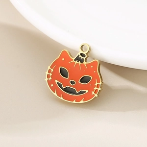 Detail of a golden Halloween cat pumpkin charm with orange and black enamel finish