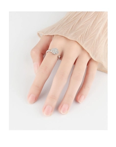 Detail of a rotating silver clover ring with sparkling crystals on an adjustable band