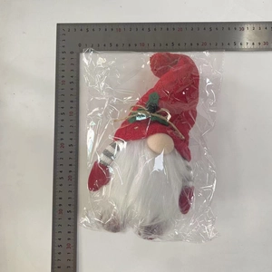 Detailed view of knitted Christmas gnome plush with measuring ruler for size check