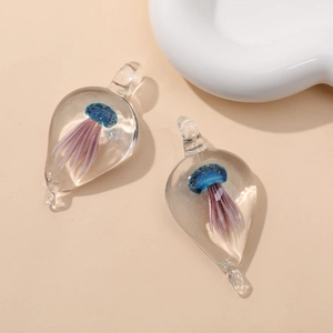 Detail of teardrop glass pendants with blue and purple 3D jellyfish interior art
