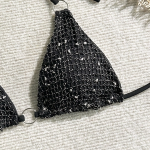 Detail of black mesh bikini top with silver metallic lurex and metal ring hardware