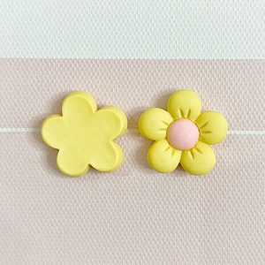 Detail of yellow and pink frosted resin flower charms for DIY crafts and phone cases