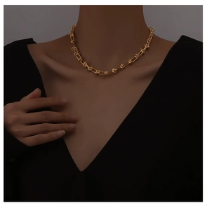 Close-up of a minimalist 18K gold-plated knotted chain necklace on a female neck