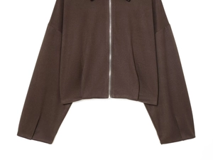Detail of dark brown bomber jacket featuring a silver metal zipper and wide cuffs