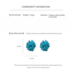 Detail view of blue beaded cluster earrings with copper rice beads and size measurements