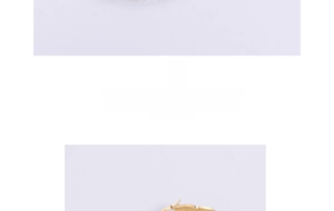 Detail of gold-plated house-shaped drop earrings with a polished surface and hooks