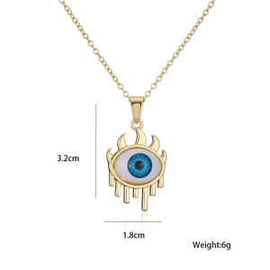 Detail showing an 18K gold plated evil eye pendant with dimensions 3.2cm by 1.8cm