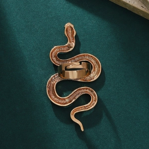 Macro shot of gold snake wrap ring featuring detailed scale texture and adjustable band