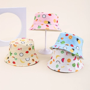 Close-up of kids bucket hats with colorful tropical fruit prints in multiple pastel colors