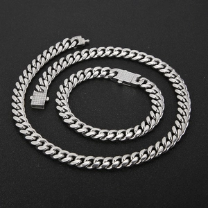 Macro shot of silver Cuban link necklace and bracelet set with CNC inlaid zircon
