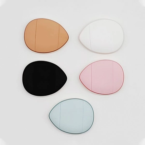 Five colorful teardrop mini finger powder puffs in orange, white, black, pink, and blue