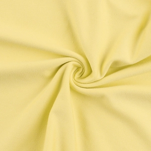 Close-up of soft pale yellow knitted fabric with fine texture and subtle draping detail
