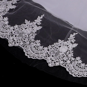 Close-up of elegant white floral embroidery lace with scalloped edges for bridal gowns