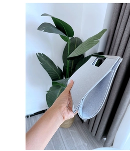Detail showing the portable gray fabric evening clutch bag in a slim folded state