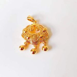 Detail of a 18k gold Ruyi lock pendant with three bells and lucky Fu character engraving