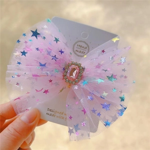 Pink mesh bow hair clip with colorful star patterns and a sparkling pink gemstone