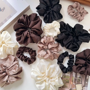 Elegant satin jumbo and small scrunchies set in earth tones for ponytail styling