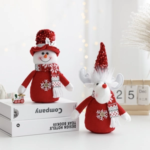 Detailed view of handmade Christmas plush snowman and reindeer figurines with red hats