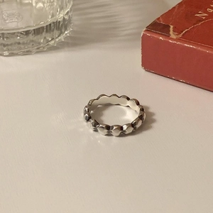 Minimalist 925 sterling silver ring with faceted texture shown at a 45-degree angle