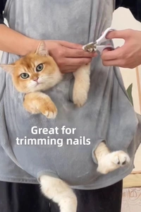 Close-up of cat grooming apron used for nail trimming with secure openings and plush fabric