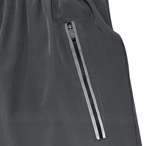 Detailed macro view of the black sporty shorts featuring a vertical side zipper pocket