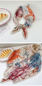 Detail of artistic pleated silk scarf with colorful abstract ink print and wavy edges