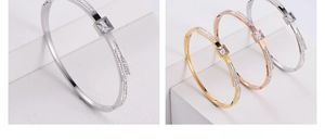 Detail of square crystal bangle with pave rhinestones in steel and 18K gold finish