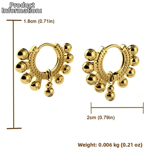 Close-up of golden spherical copper earrings with 1.8cm height and 2cm width dimensions