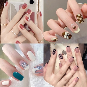 Collage of four diverse press-on nail styles featuring pearls, bows and flame designs
