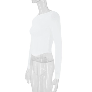 Detail view of the side profile and curved hemline on a white slim mesh crop top