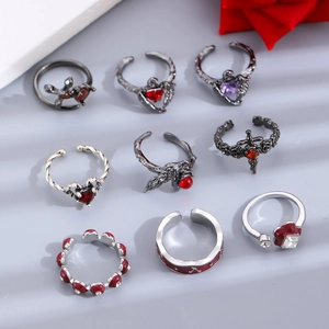 Gothic ring set with dark thorns, cross, and heart details in silver and black gunmetal