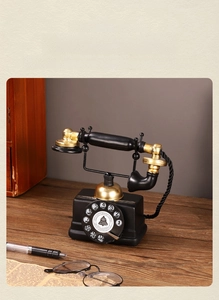 Macro detail of resin vintage telephone model with hand-polished black and gold finish