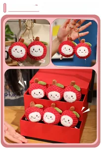 Close-up of handmade crochet lychee keychain with cute smile face and golden clip