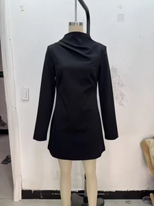 Detail of black long sleeve mini dress featuring elegant pleated draped neckline design